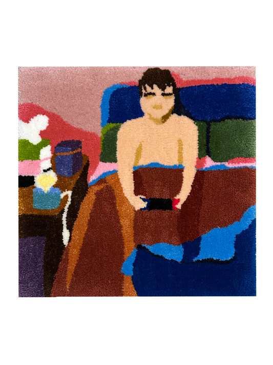 Rug with a stylized depiction of a person sitting in bed, playing video games by lamplight