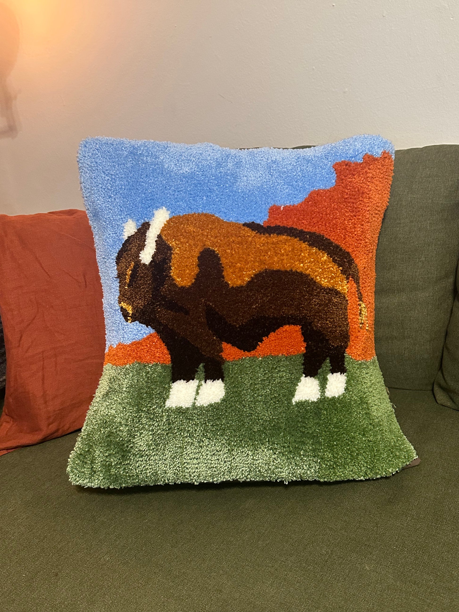 Decorative pillow with a bison design on a couch