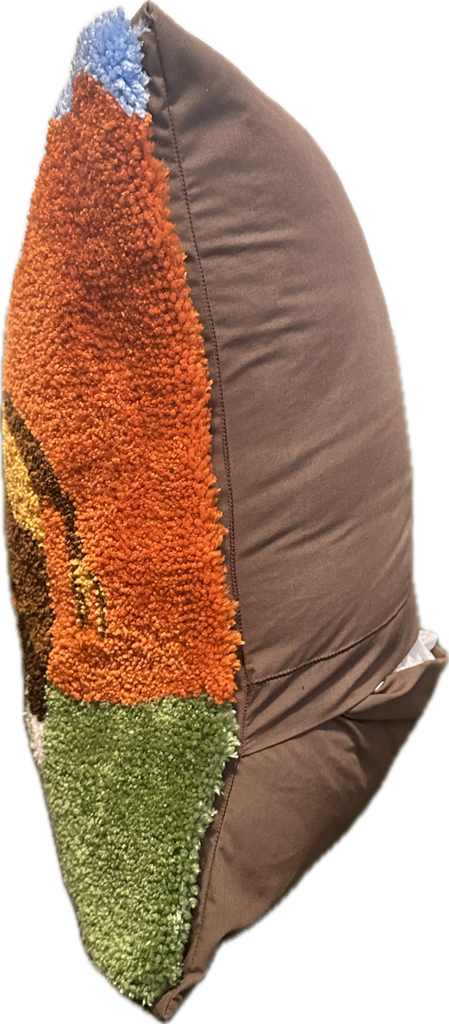 Textured pillow with brown, orange, and green patterns on a white background
